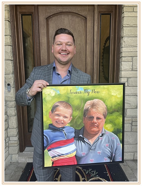 Steve Johnson holding the 'Forever My Hero' painting of him and his father